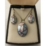 A 925 silver pendant and matching earrings set with mosaic style pink and blue mother of pearl.