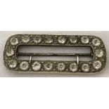 A Victorian Silver buckle with set with 18 clear paste stones.