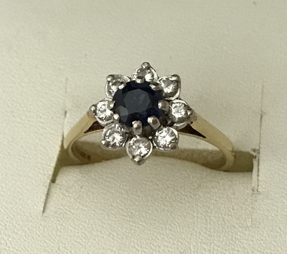 A 18ct gold yellow gold sapphire and diamond dress ring.