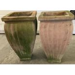 A pair of terracotta plant pots with fluted design sides.