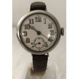 A hallmarked silver cased WWI trench watch on brown leather strap.