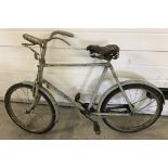 A 1950's child's bicycle with blue paintwork and original leather seat.