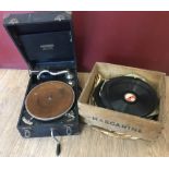 A Mastertone Junior gramophone together with a box of records.