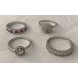 4 silver and white metal dress rings.