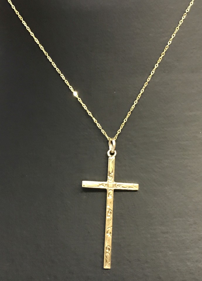 A 9ct gold cross with delicate engraved decoration on a fine 18 inch gold chain.