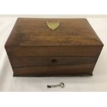 A small wooden box lined with velvet with brass lock and fixings.