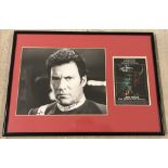 A framed and glazed photo of Captain Kirk from " The Search For Spock" signed by William Shatner.