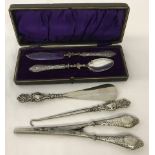 A collection of silver handles items.