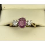 An 18ct yellow gold, 3 stone ruby and diamond dress ring.