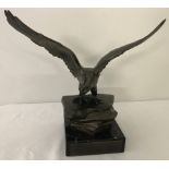 A bronze lacquered figure of an eagle.