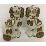 A pair of copper lustre Staffordshire Fireside dogs.