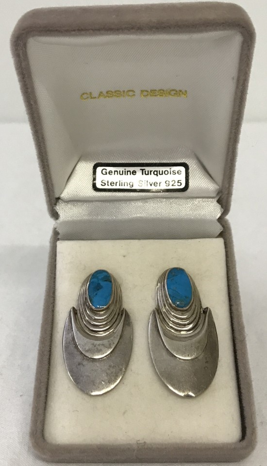 A boxed pair of unmarked silver and turquoise contemporary design earrings.