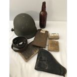 A box of mixed military items.