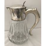 A heavy cut glass Punch jug with ice cube cooler. Silver plated lid and handle.