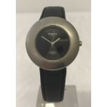 A Leijona titanium cased quartz wristwatch with black dial and black leather strap.
