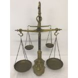 An unusual set of double brass balance scales with weights.