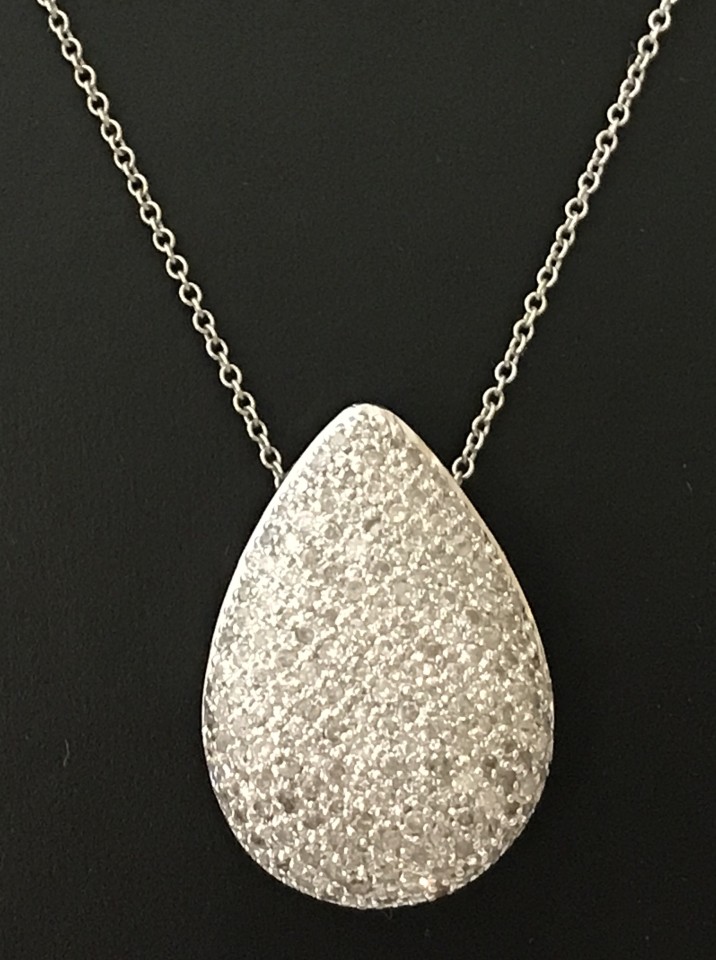 A 9ct white gold teardrop pendant set with 100+ small sparkling diamonds.