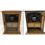 An oak smokers cabinet with glass panel door.