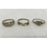 3 silver rings of different designs.