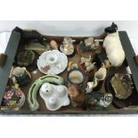 A box of assorted ceramic and resin figurines.