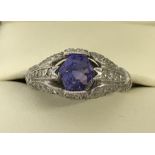 An Art Deco style platinum dress ring set with central hexagon cut blue/violet sapphire.