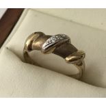 A 9ct gold unusual design yellow gold ring set with 2 small diamonds.