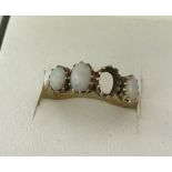 Vintage 9ct gold ring set with oval opals.