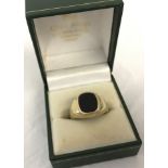 A gents 9ct gold signet ring with vacant black onyx face.