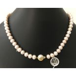 A single row uniform pink cultured pearl with 2 tone 9ct gold clasp.