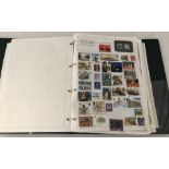 A green ring binder stamp album containing world stamps.