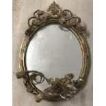 An antique oval mirror with moulded gilt frame