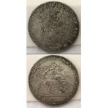 An 1820 George III silver crown coin.