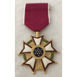 A U.S Legion of Merit Commander medal on pink ribbon.