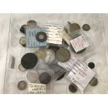 A tray of old coins and tokens.