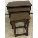 A dark oak old charm style nest of tables.