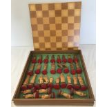 A modern wooden cased chess set with lift off lid / playing board.