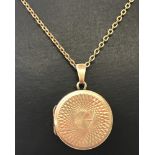 A small circular 9ct back and front locket on a 9ct gold chain.