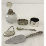 A collection of hallmarked silver items to include silver collared scent bottle, napkins rings and