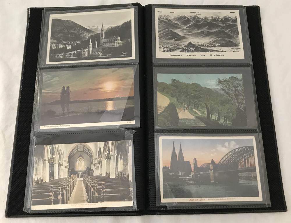 A slim brown album of vintage postcards.