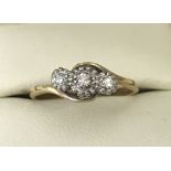 An 18ct gold and platinum diamond set trilogy ring. Approx. diamond carat .15ct