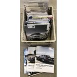 A box of BMW car magazines and factory catalogues.