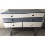 A Schreiber 6 drawer chest of drawers. Painted cream and grey.