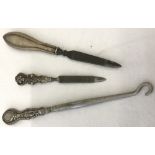 3 silver handled ladies vanity items, a button hook together with 2 nail files.