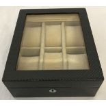 A brand new boxed Black geometric design watch box with glass top by Walwood.