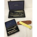 A collection of vintage boxed drawing instruments.