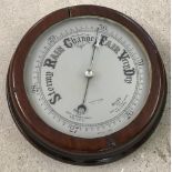 A dark oak surround vintage wall barometer.