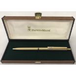 A boxed Papermate powerpoint gold pen.