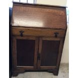 A small dark oak Art Deco bureau with single drawer and 2 door cupboard.