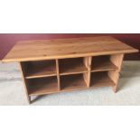 A modern pine coffee table with sectional compartments.