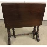 A Mahogany miniature Sutherland table to gate legs on castor feet.